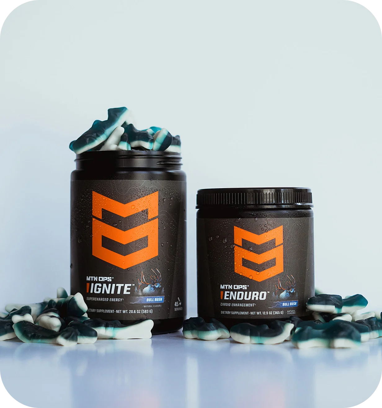 MTN OPS product photo of Ignite and Enduro supplement tubs surrounded by gummies.