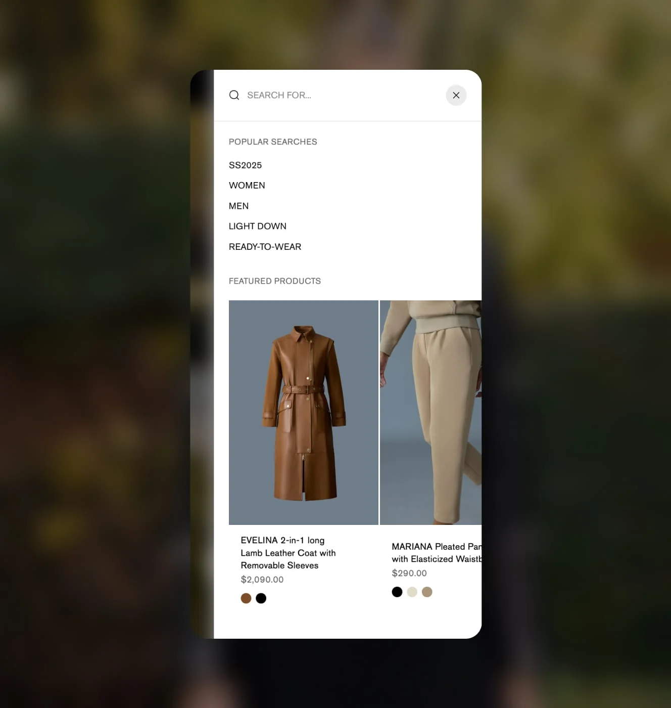 Mackage search overlay with popular search terms and featured product cards for a leather coat and pleated pants.