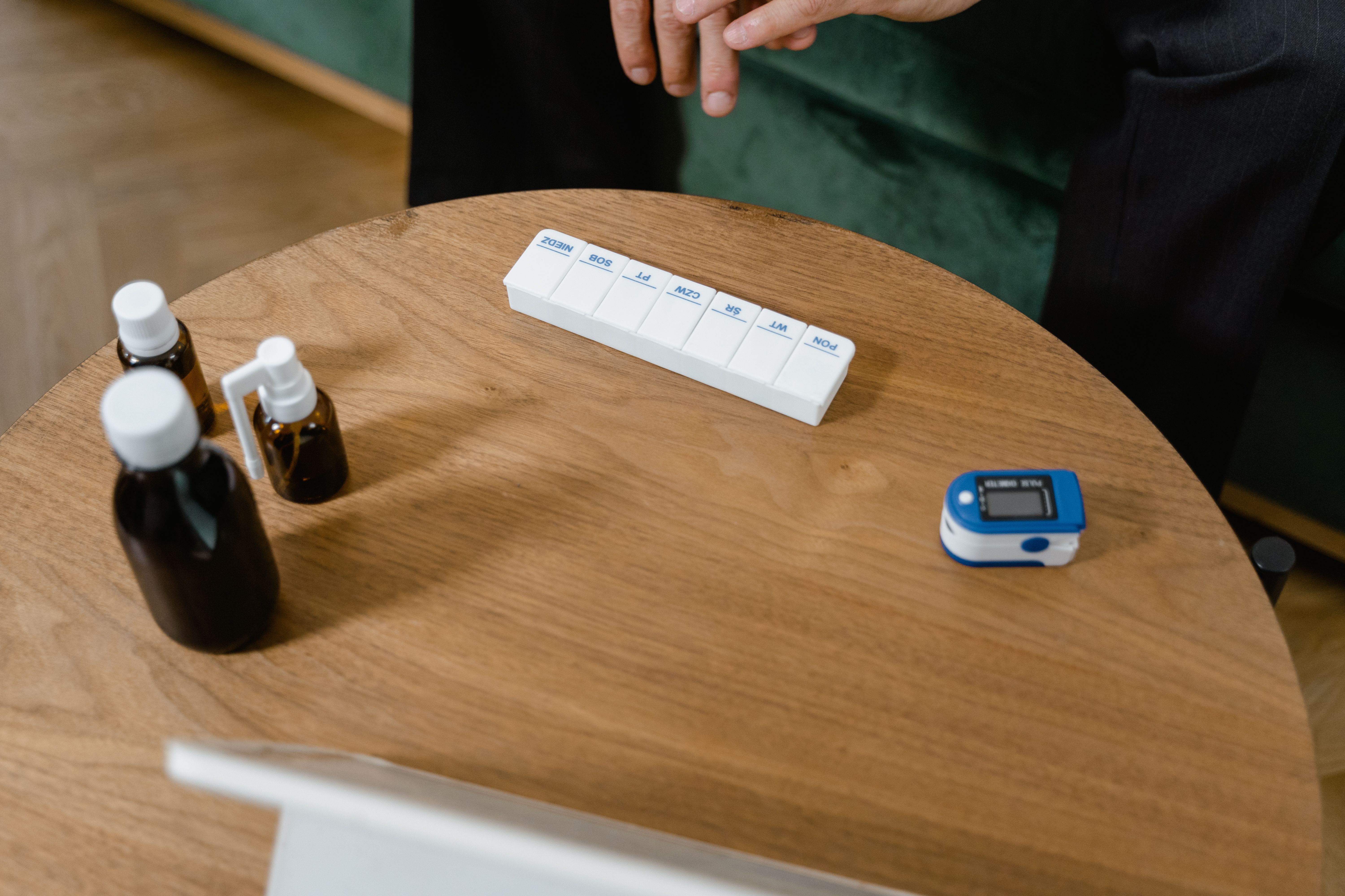 Pill organizer and medication bottles on a table