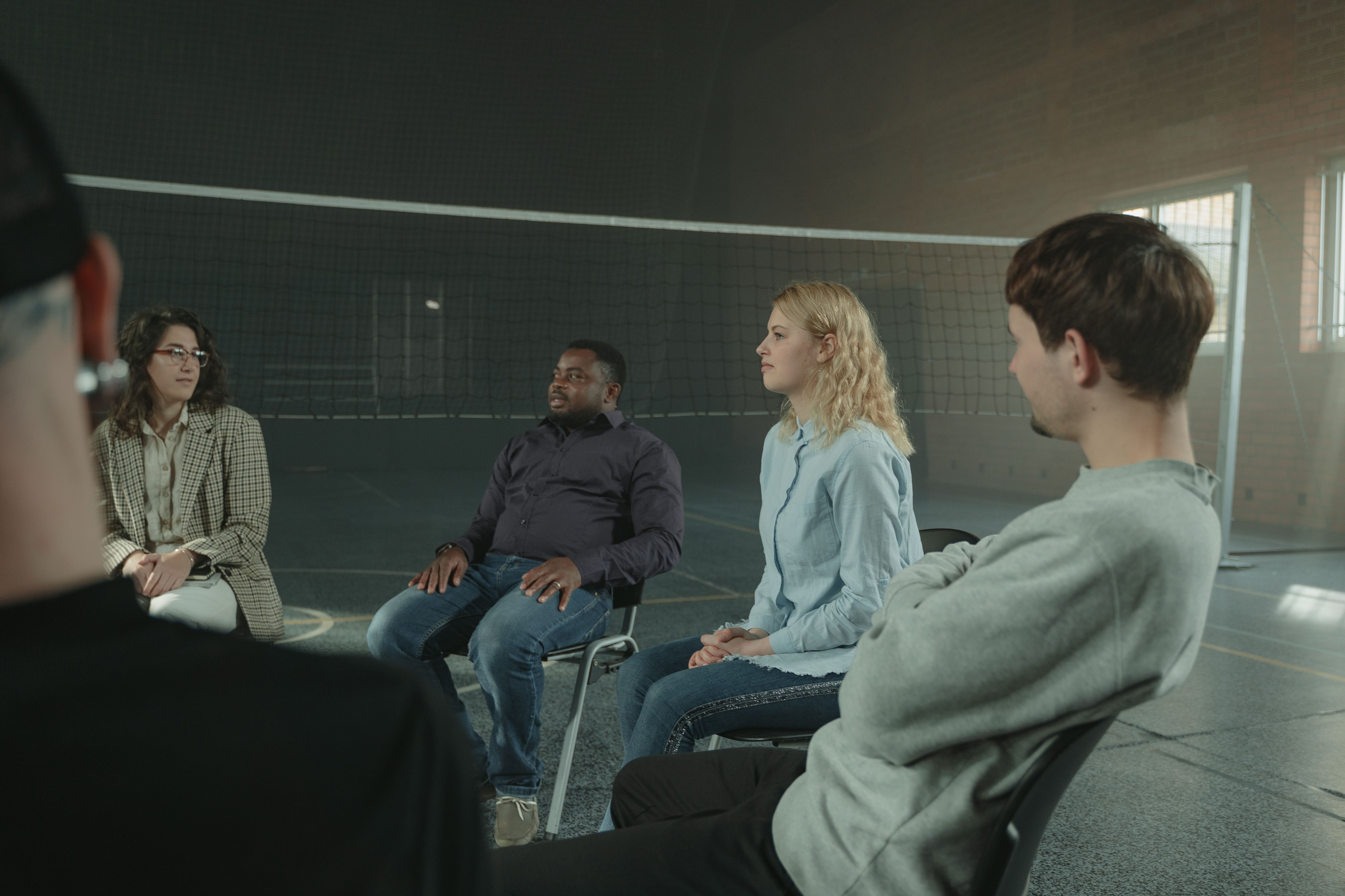 Group of adults in a supportive group therapy discussion