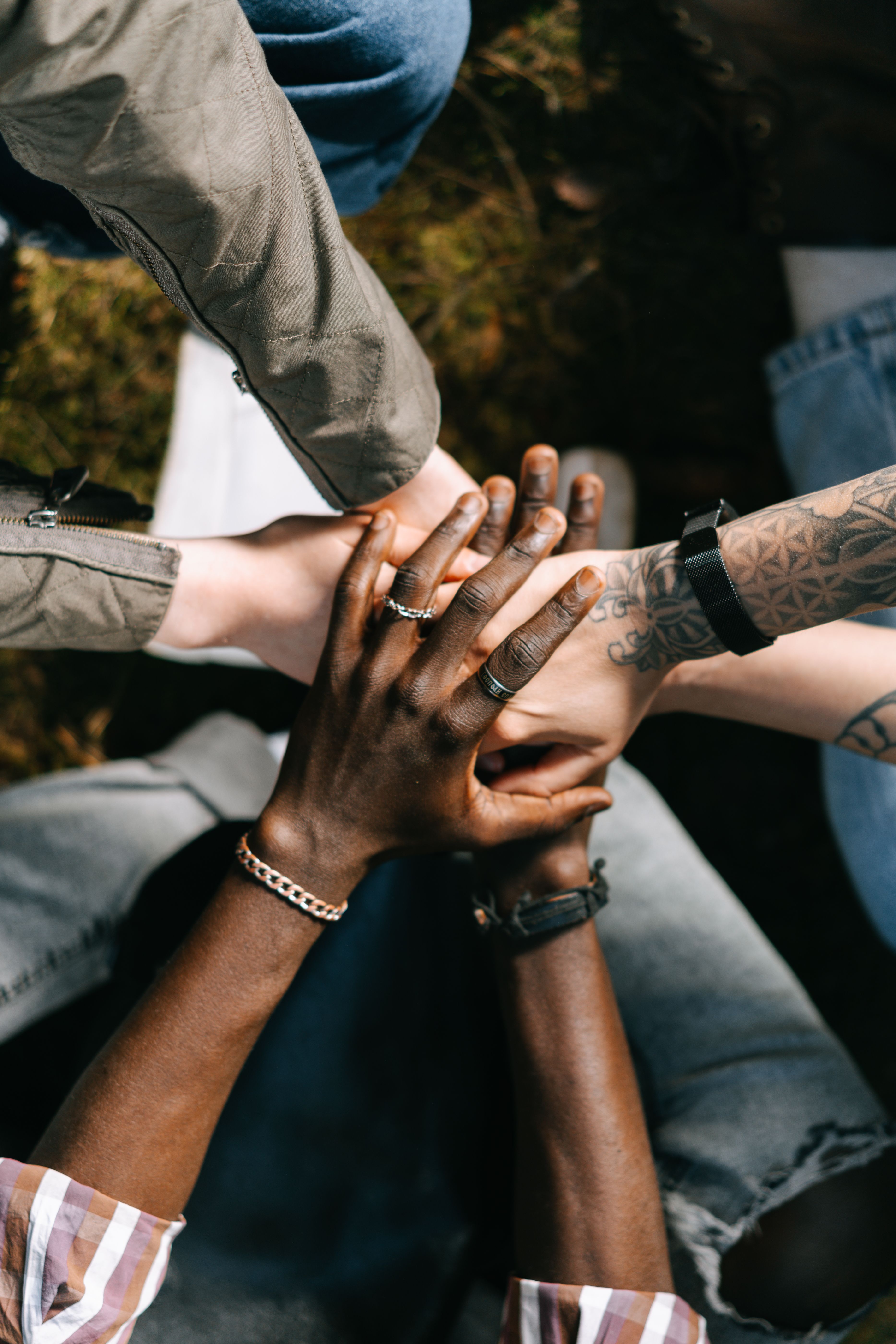 Group of people joining hands in a show of support