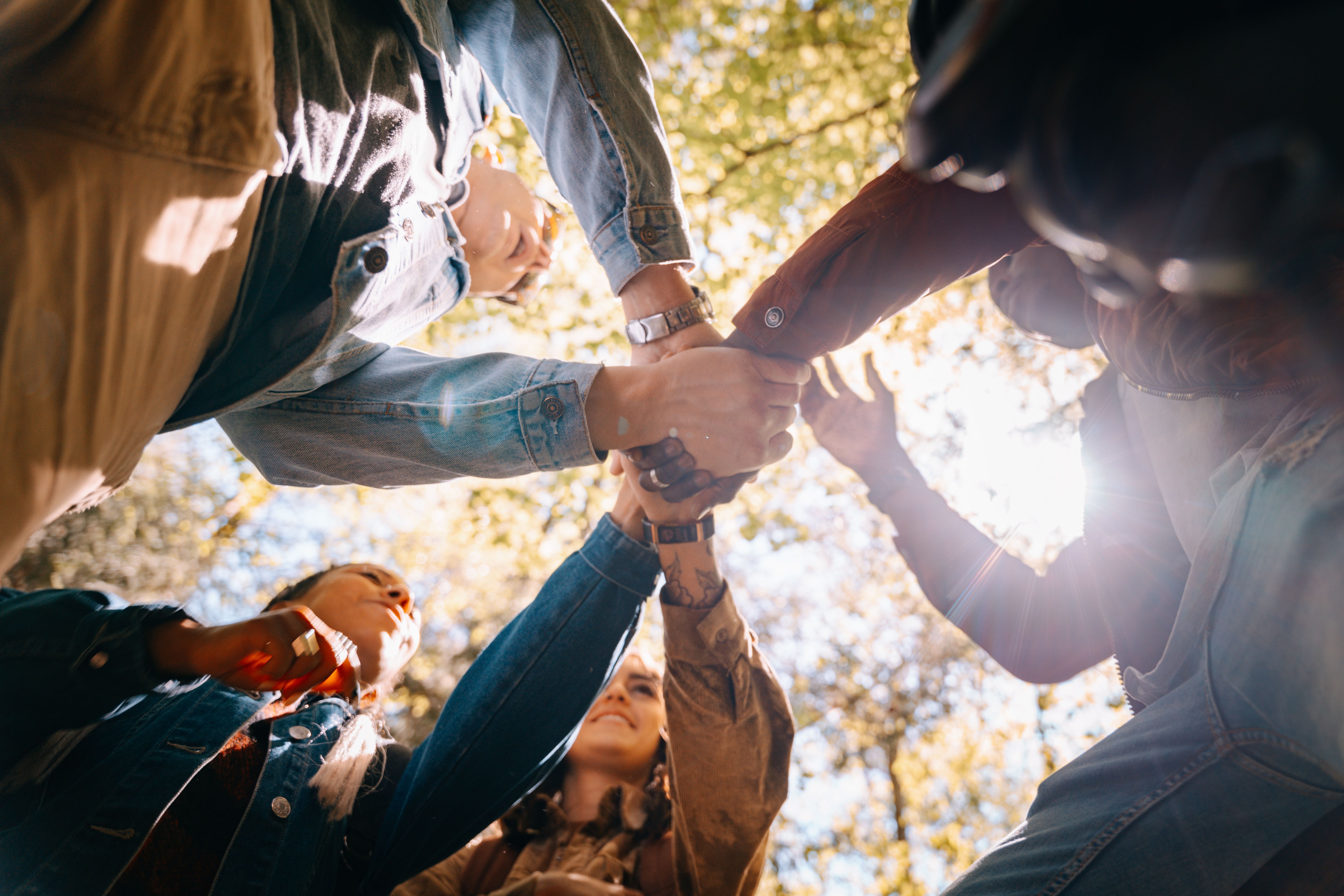 People placing their hands together in unity