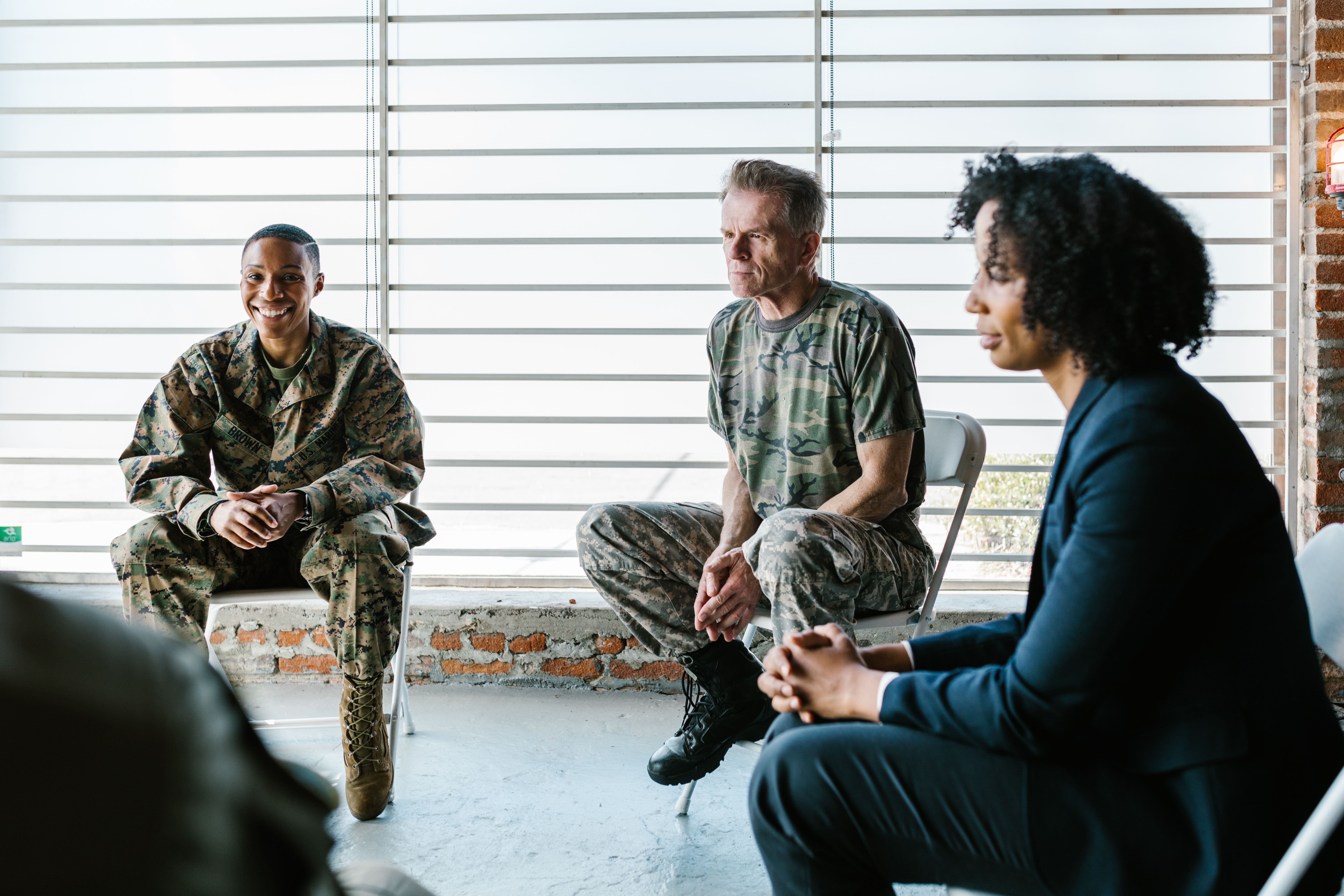 Group therapy session with veterans and a mental health professional