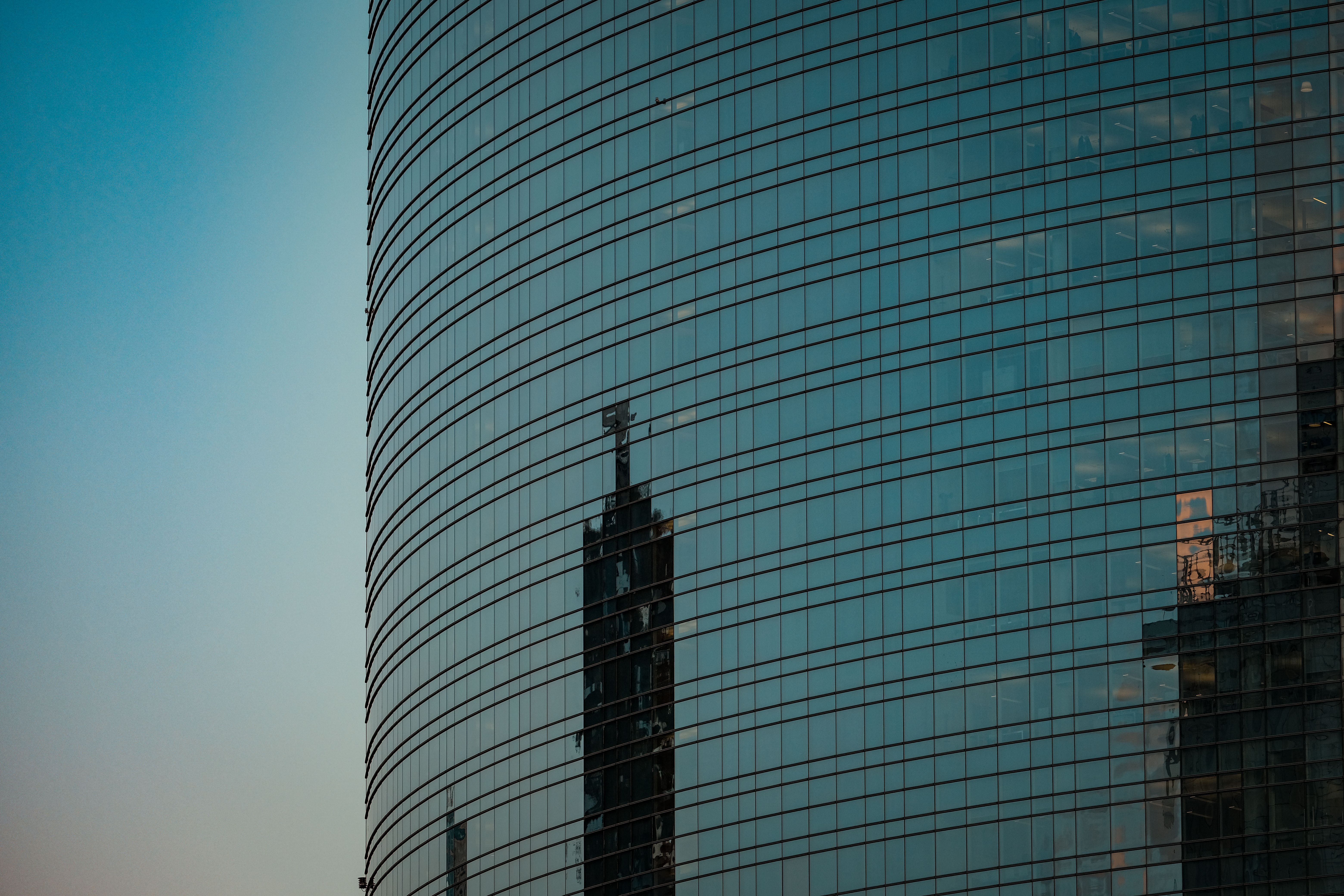 Modern glass office building representing insurance and healthcare coverage