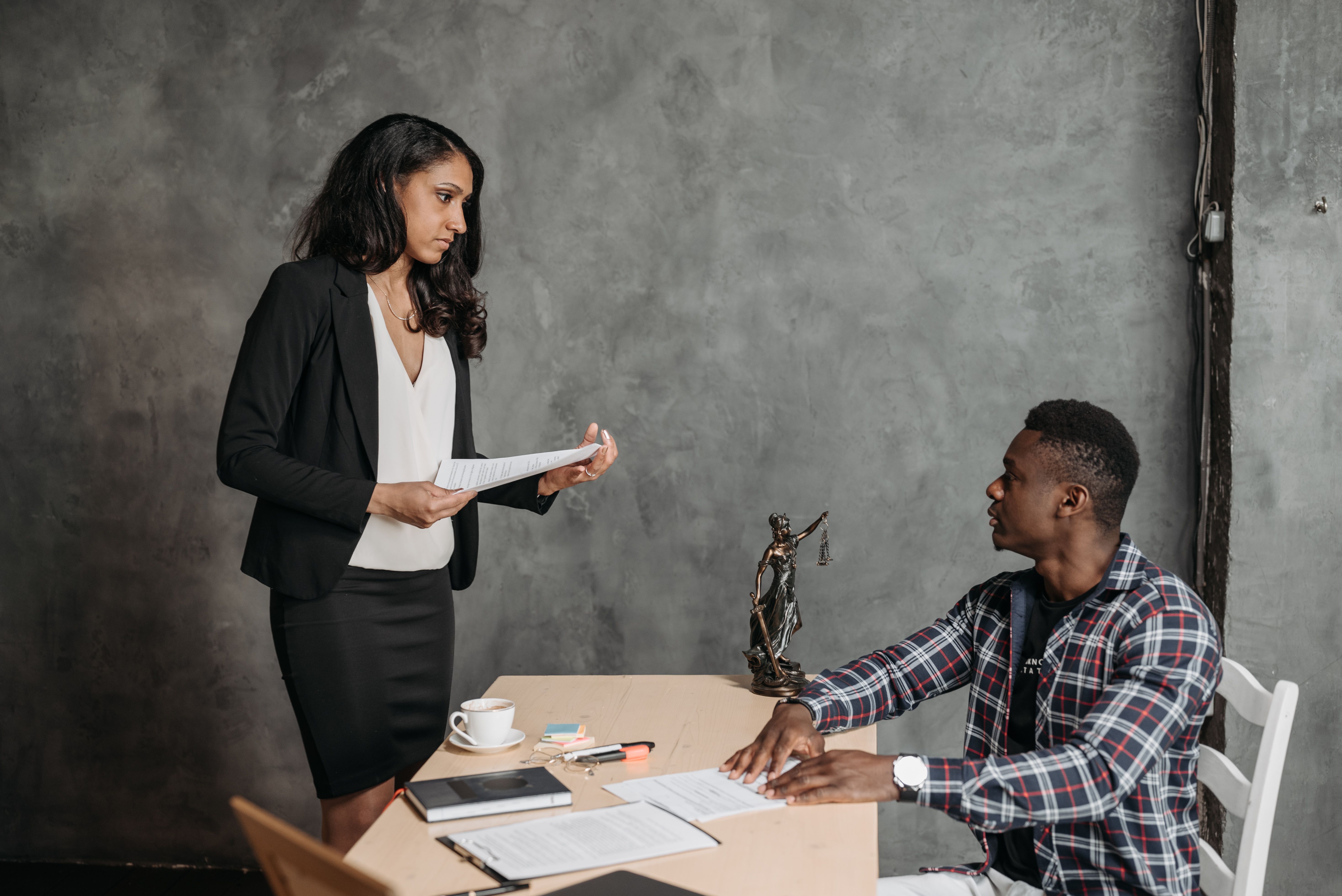 Two professionals reviewing documents at a desk