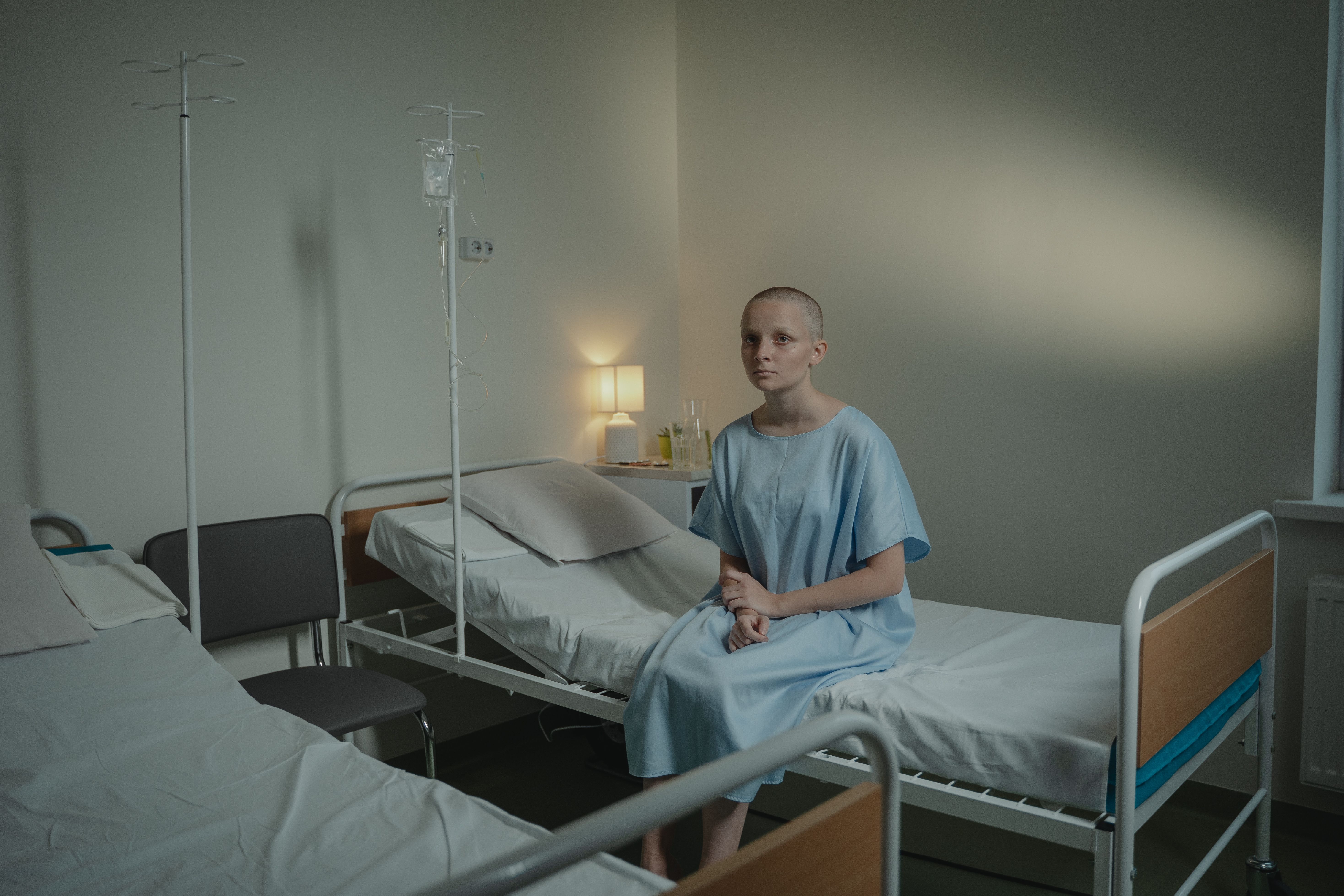 Patient sitting quietly on a hospital bed