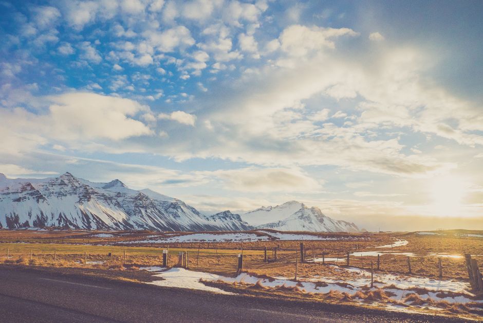 A stunning view of snow-capped mountains and blue skies during sunrise.