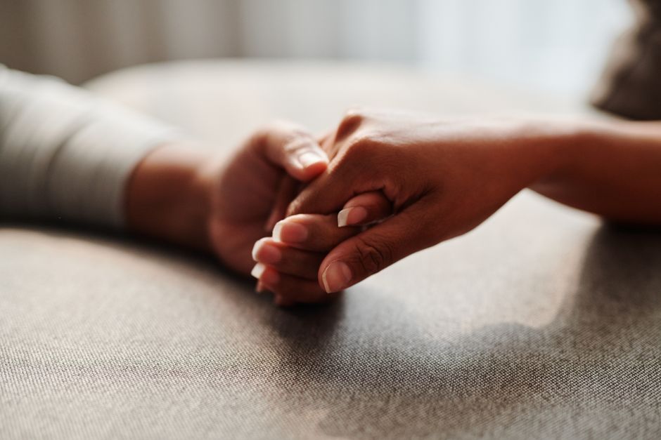 A close-up shot of two hands holding, symbolizing connection and support.