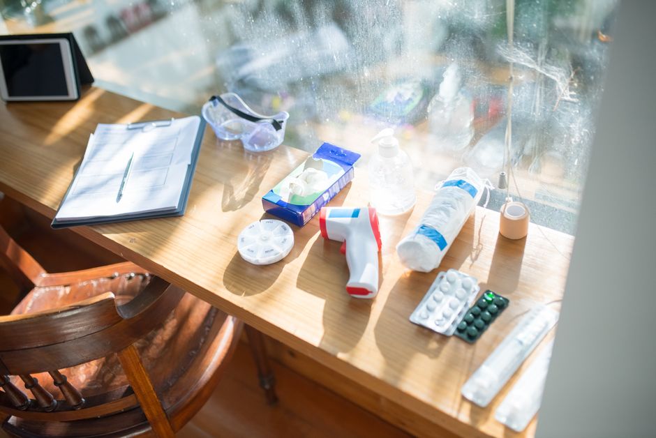 A sunlit desk with medical supplies and a clipboard, perfect for home healthcare concepts.