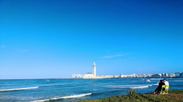 white lighthouse near body of water during daytime