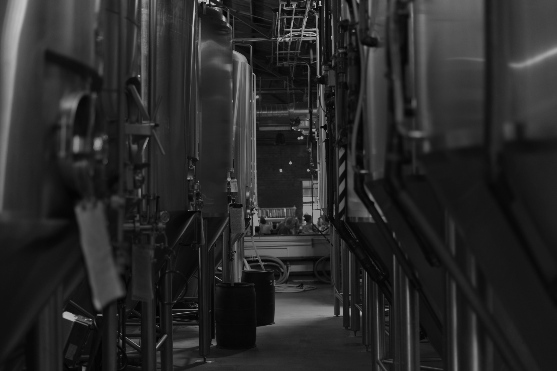 Hank's Distillery facility — stainless tanks, black and white