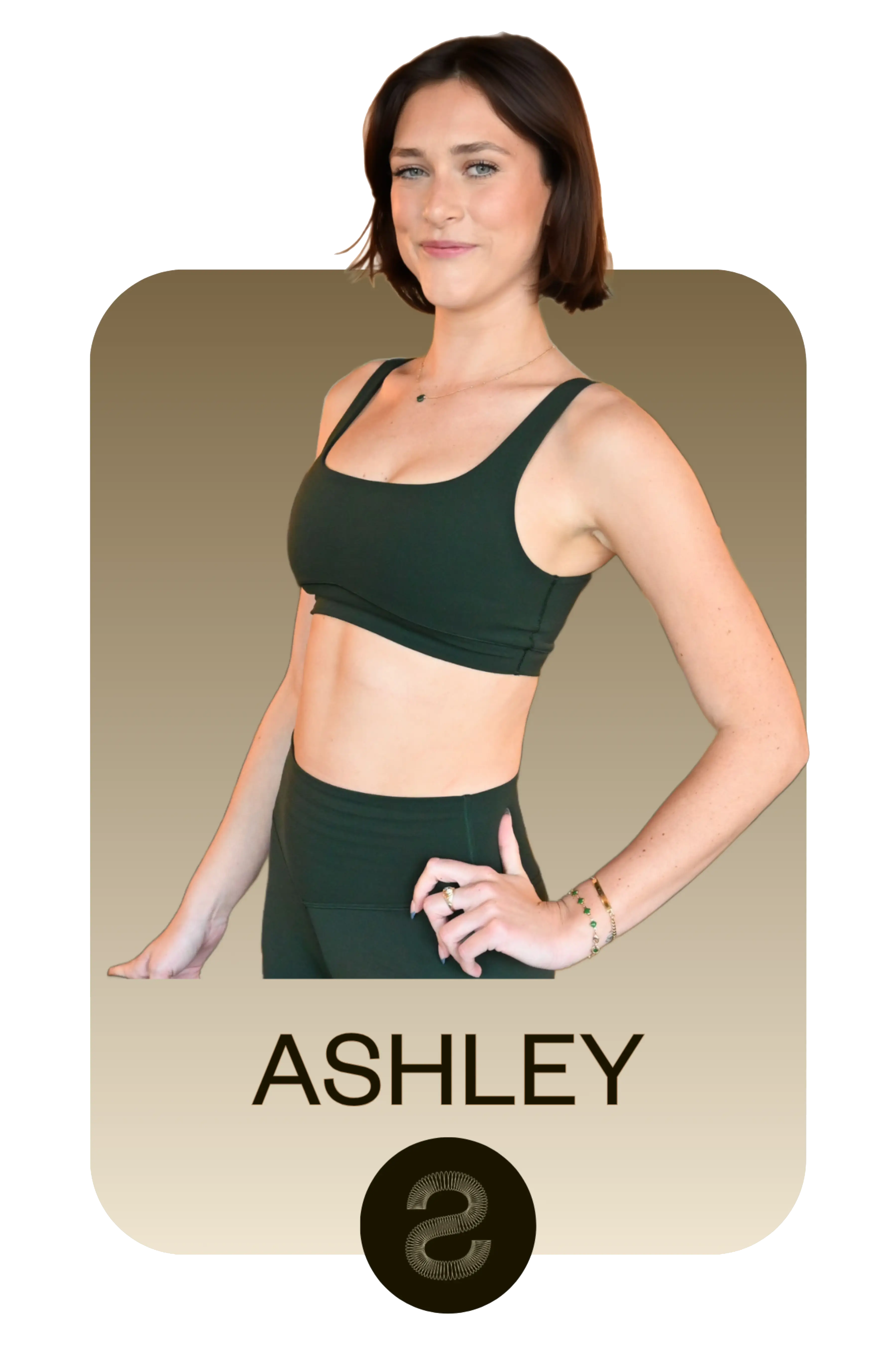 Young woman named Ashley wearing a dark green sports bra and matching leggings, posing with one hand on her hip against a gradient beige background.