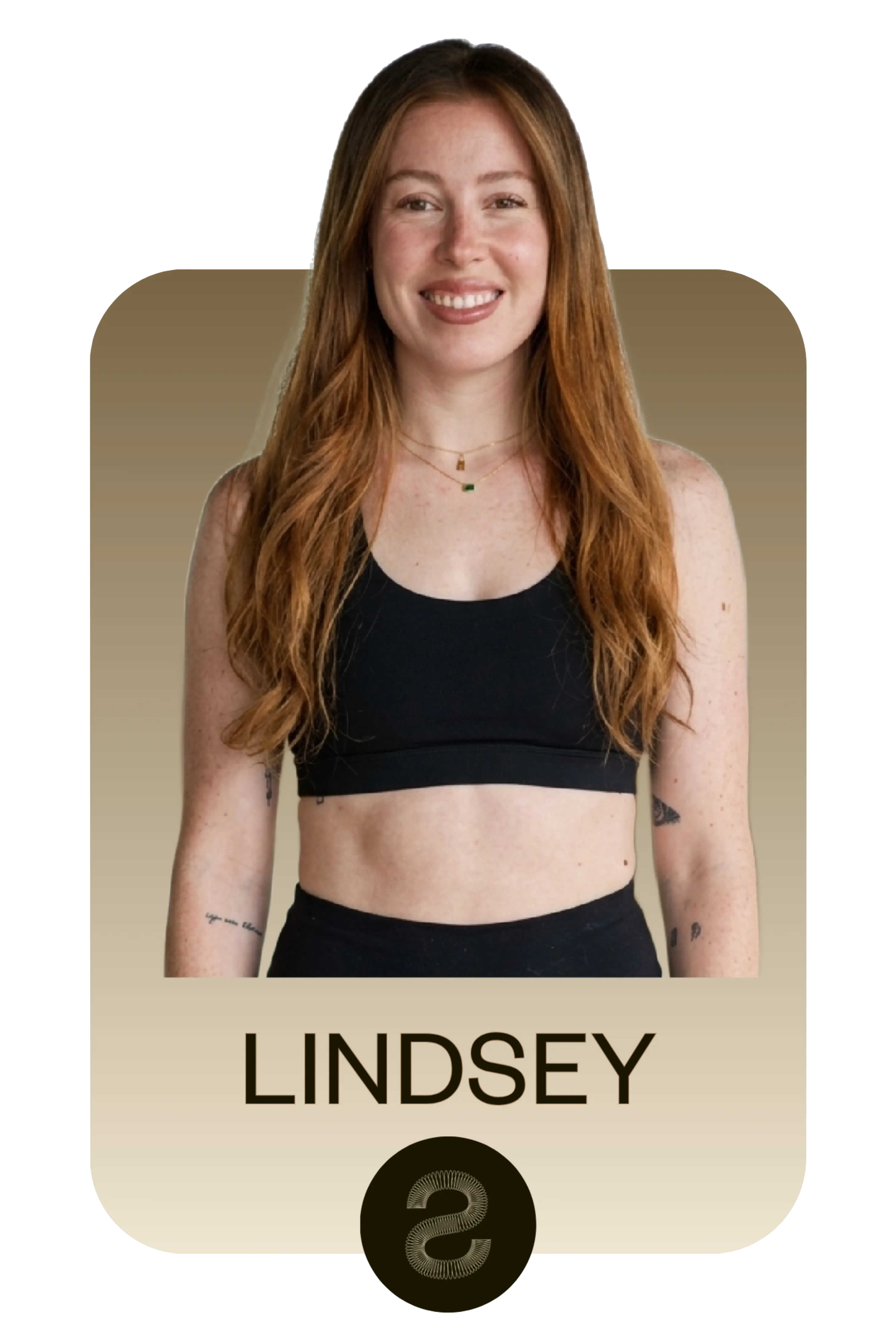 Smiling woman with long red hair wearing a black sports bra and black pants, with tattoos on her arms against a gradient beige background with the name Lindsey below.