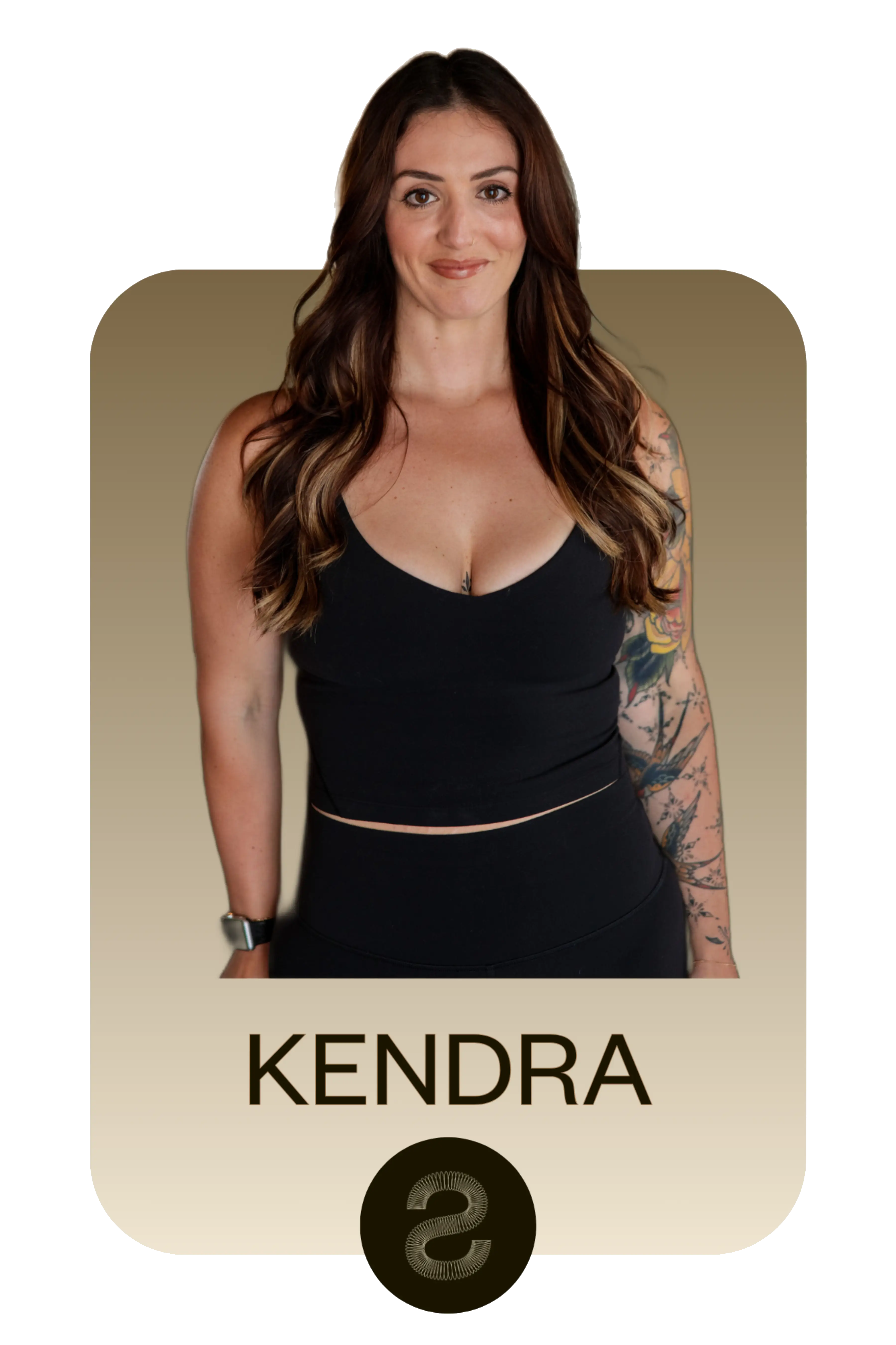 Woman with long brown hair and floral sleeve tattoo wearing a black sleeveless top and black pants, smiling at the camera, with KENDRA text below.