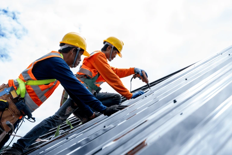 Two man working on fixing the roof
