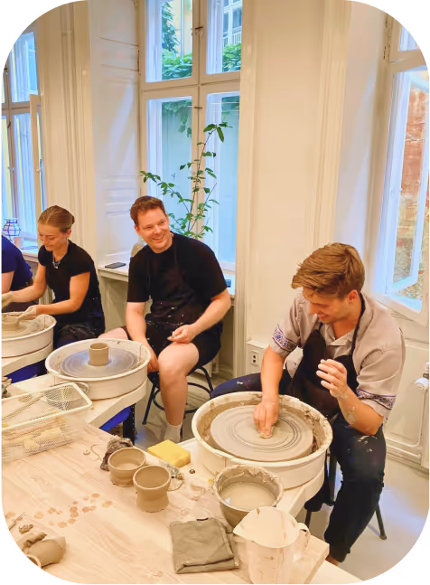Colleagues enjoying a pottery workshop as a creative team-building activity.