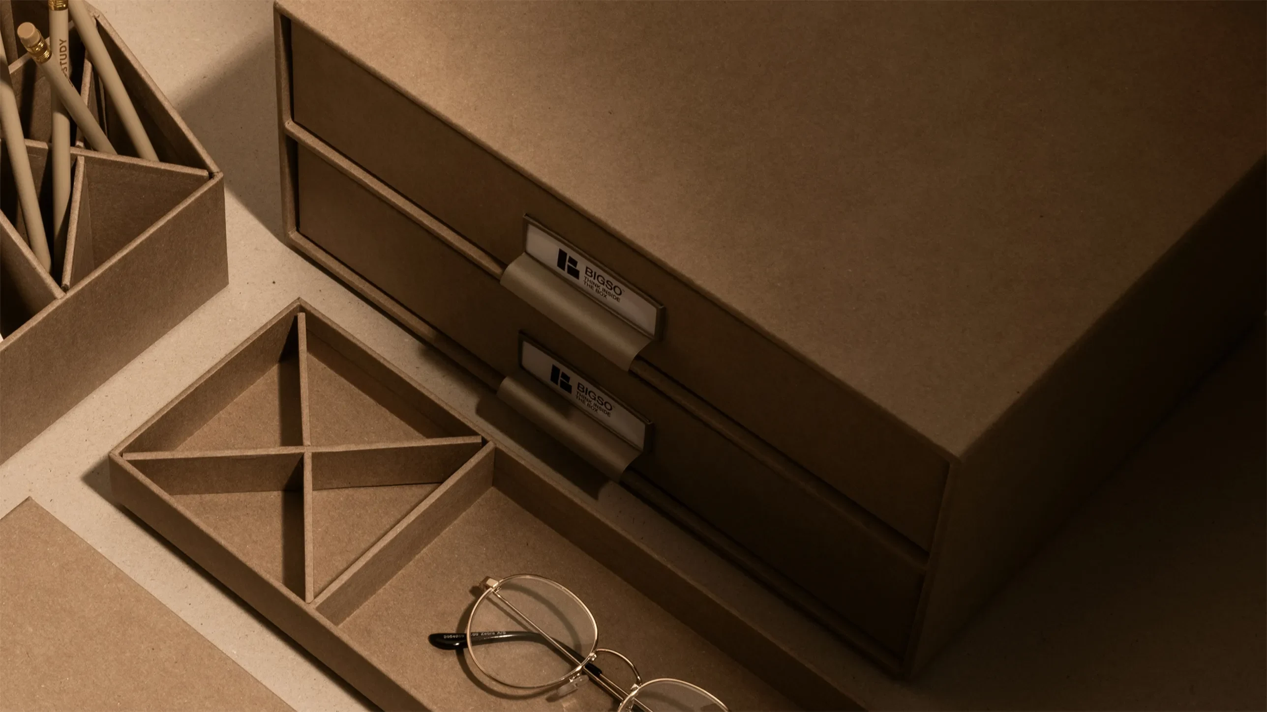 Bigso brown cardboard desk organizers with labeled drawers, compartment trays, and pencil holders for stylish and functional home office storage.