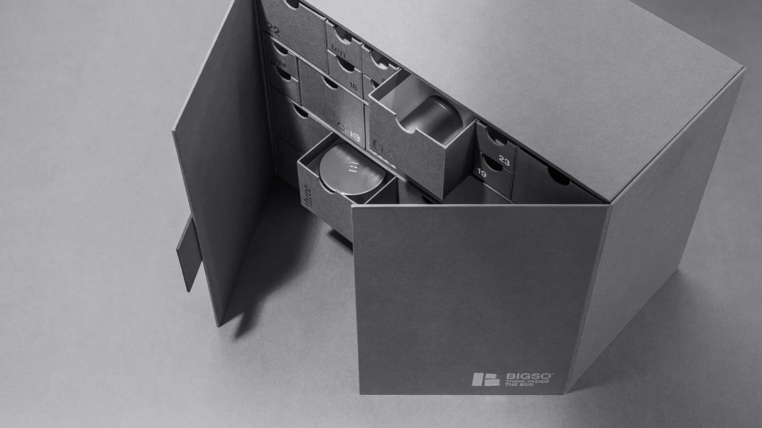 Bigso grey cardboard packaging unit with numbered pull-out drawers, designed for premium product storage and organized presentation.