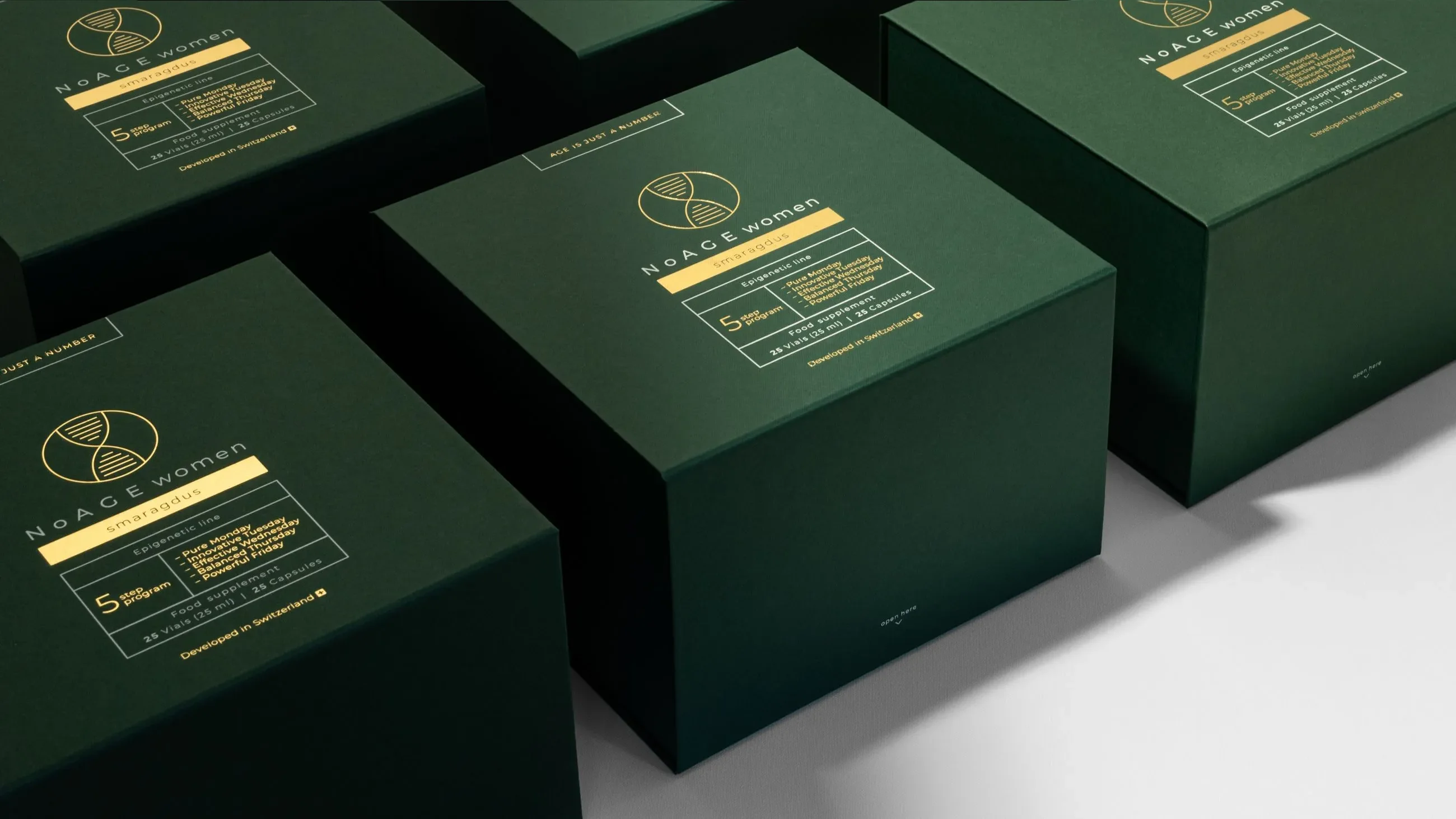 Luxury dark green NoAGE Women Smaragdus packaging cases manufactured by Bigso, featuring gold detailing and designed for premium supplement presentation.