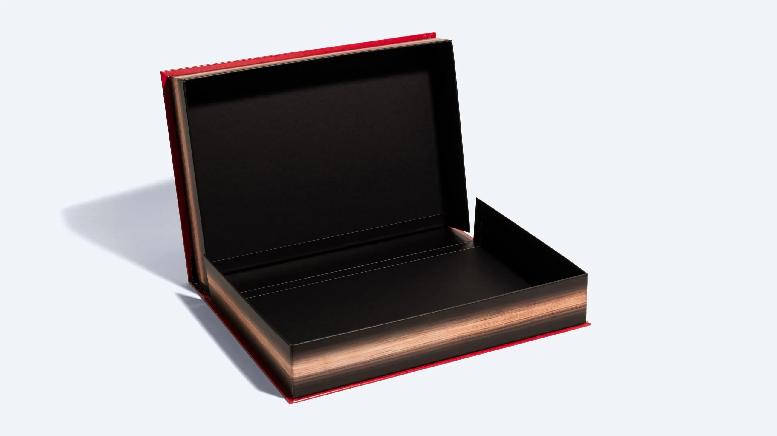 A clamshell-style packaging box featuring a hinged lid and sturdy base for premium product presentation.