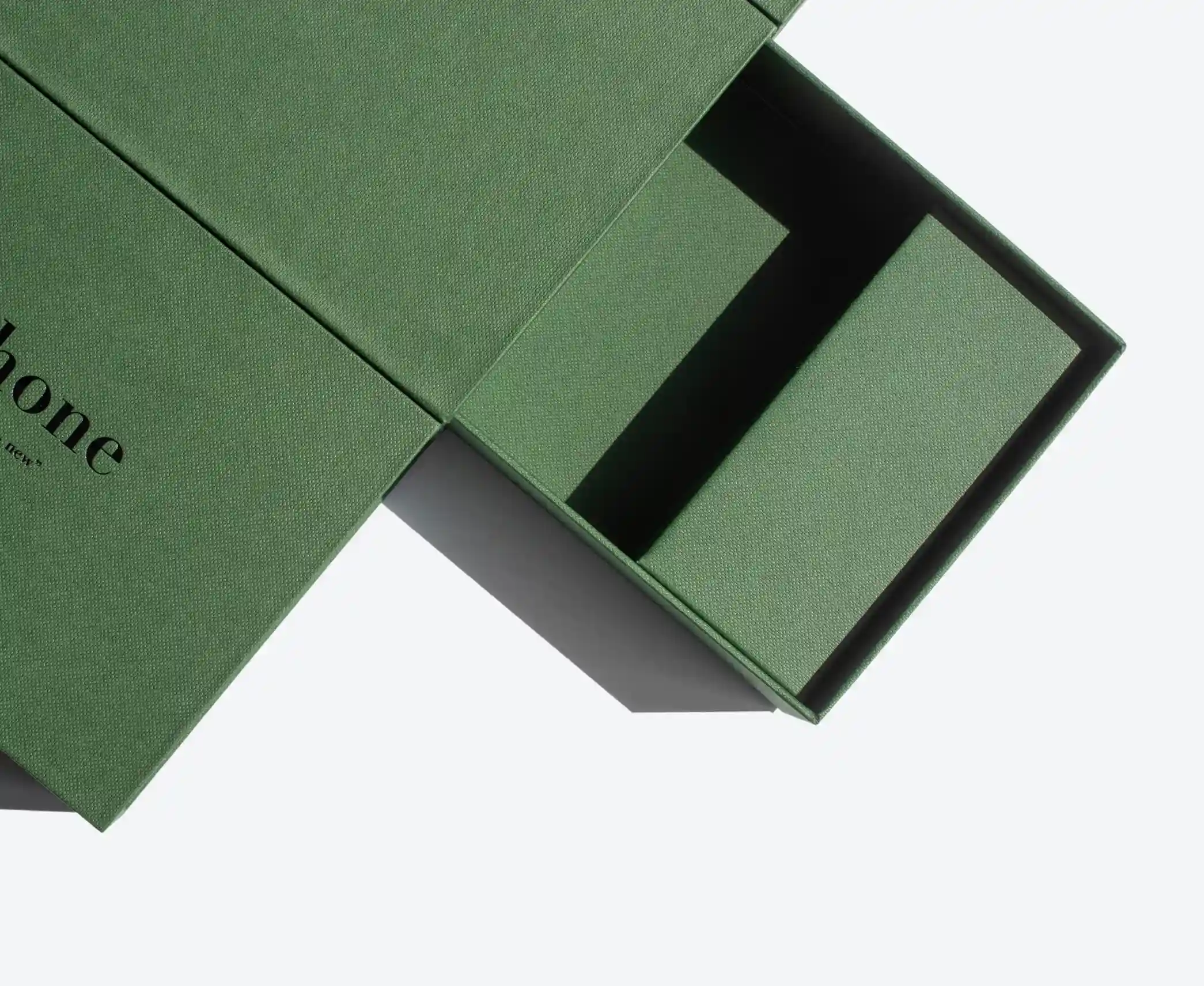 Close-up of a green rigid drawer box with the inner tray sliding open, revealing its structure.