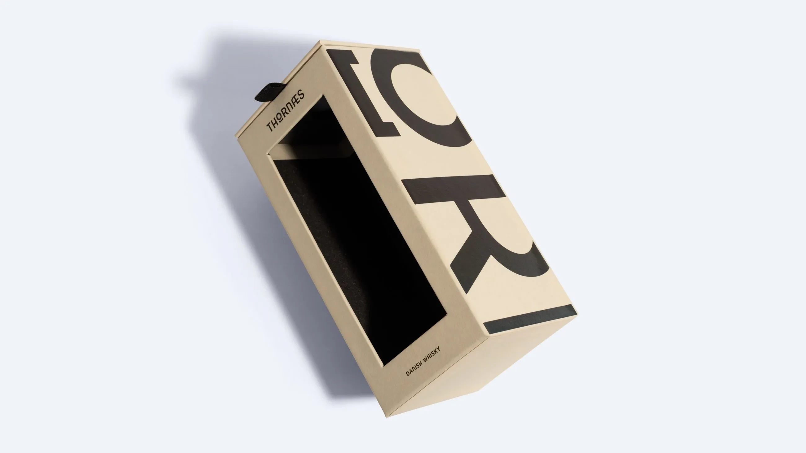 Beige hinged lid box with bold black typography and a transparent window on the front.