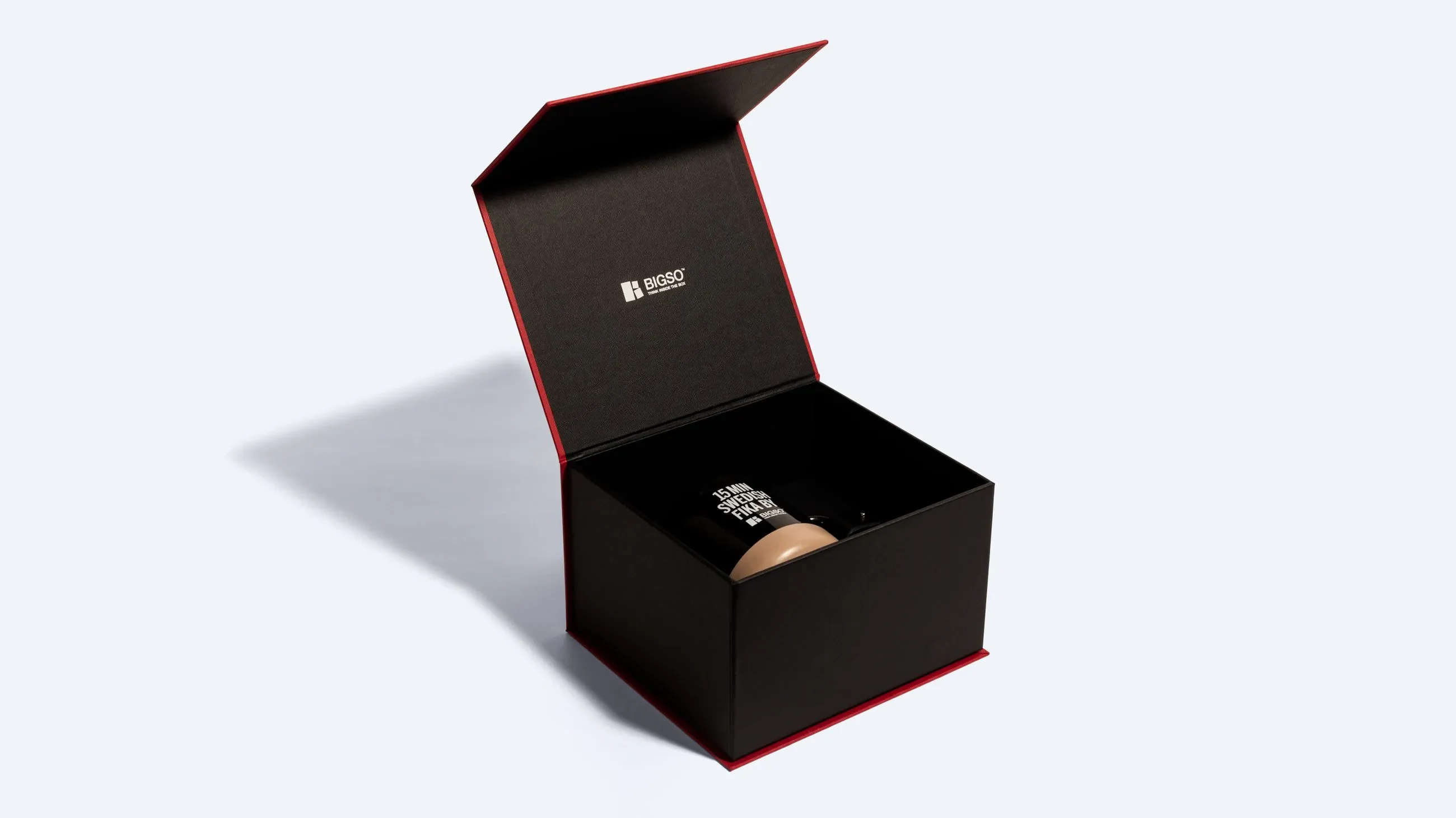 A black and red magnetic rigid box shown open, revealing a mug inside and the Bigso logo printed on the interior lid.