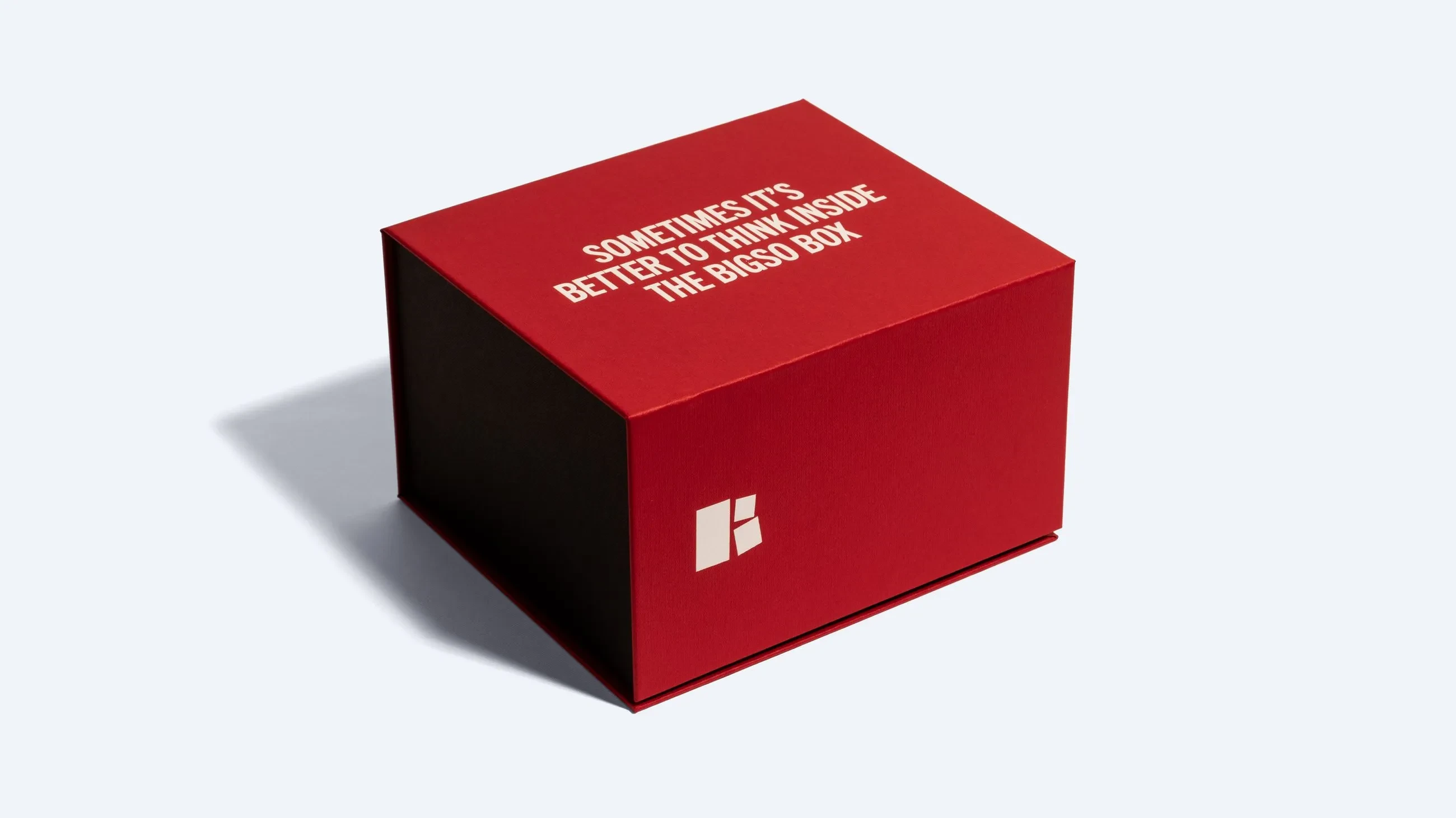 A red and black magnetic rigid box with white text on the lid that reads “Sometimes it’s better to think inside the Bigso Box.”