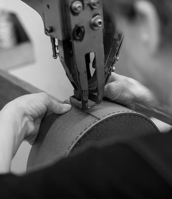 Close-up of a craftsman riveting a round sustainable storage box at Bigso’s production facility. Showcasing precision manufacturing, traditional techniques, and eco-friendly packaging craftsmanship.