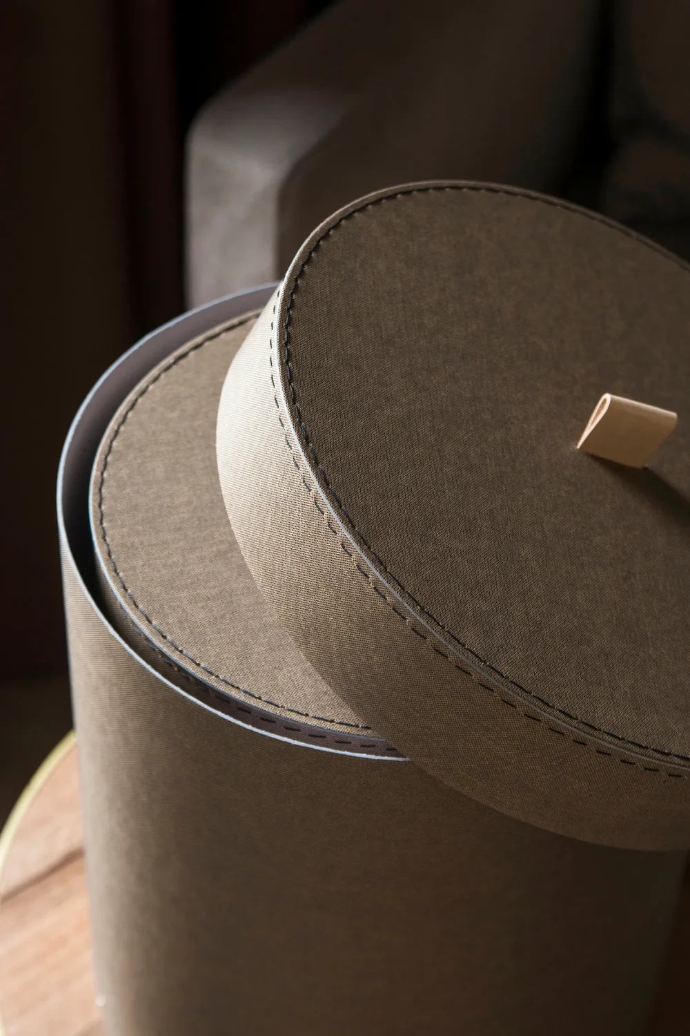 Round storage box made from recycled textile material with stitched detailing and a leather pull tab. Bigso’s eco-friendly design highlights sustainable craftsmanship, combining durability with modern Scandinavian style for home organization and decorative storage.