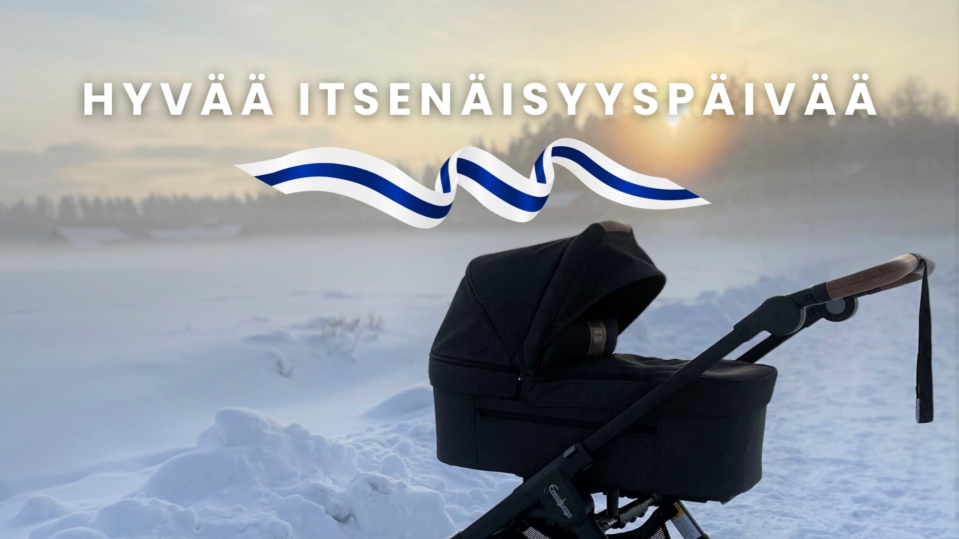 Teksti: Hyvää itsenäisyyspäivää. Kuvan etualalla mustat Emmaljunga lastenvaunut lumista järven jäätä, metsää ja laskevaa aurinkoa vasten.
