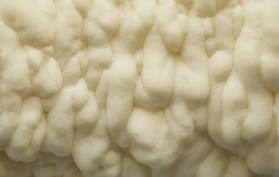 Close-up texture of fluffy white blown-in attic insulation material