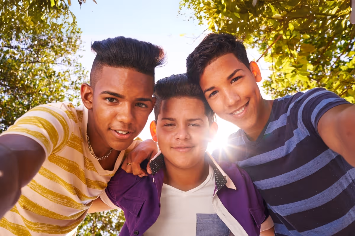 3 boys in a park taking a selfie