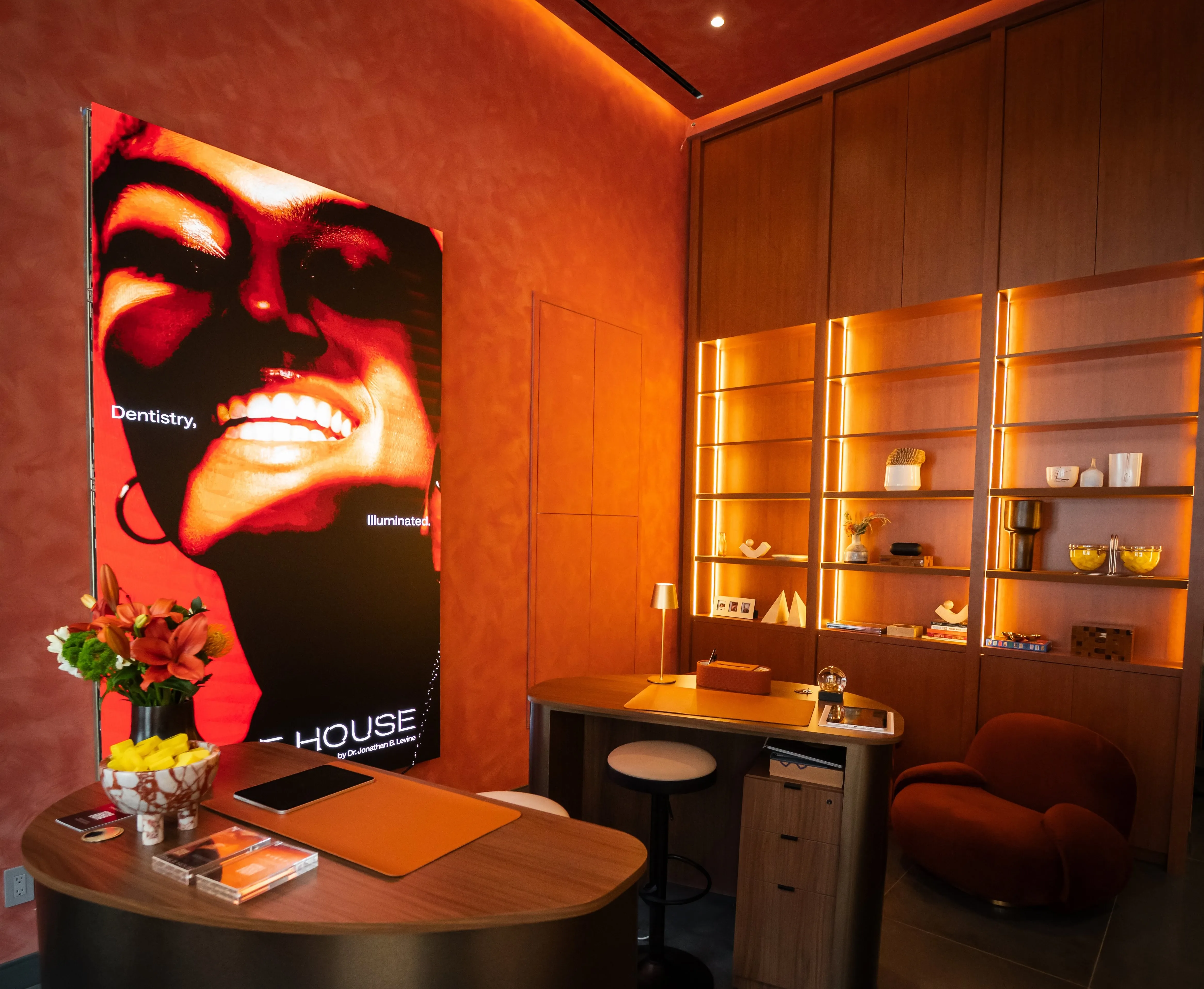 Smile House consult room with brand artwork and backlit shelving
