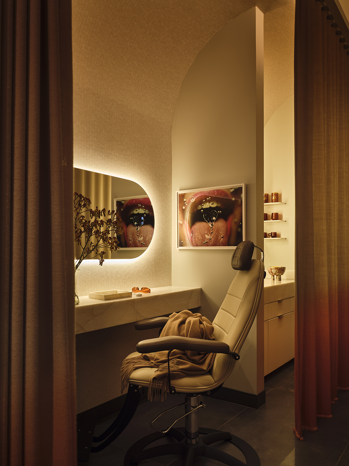 The Smile Bar at Smile House: a backlit vanity nook with macro mouth artwork and a cashmere throw