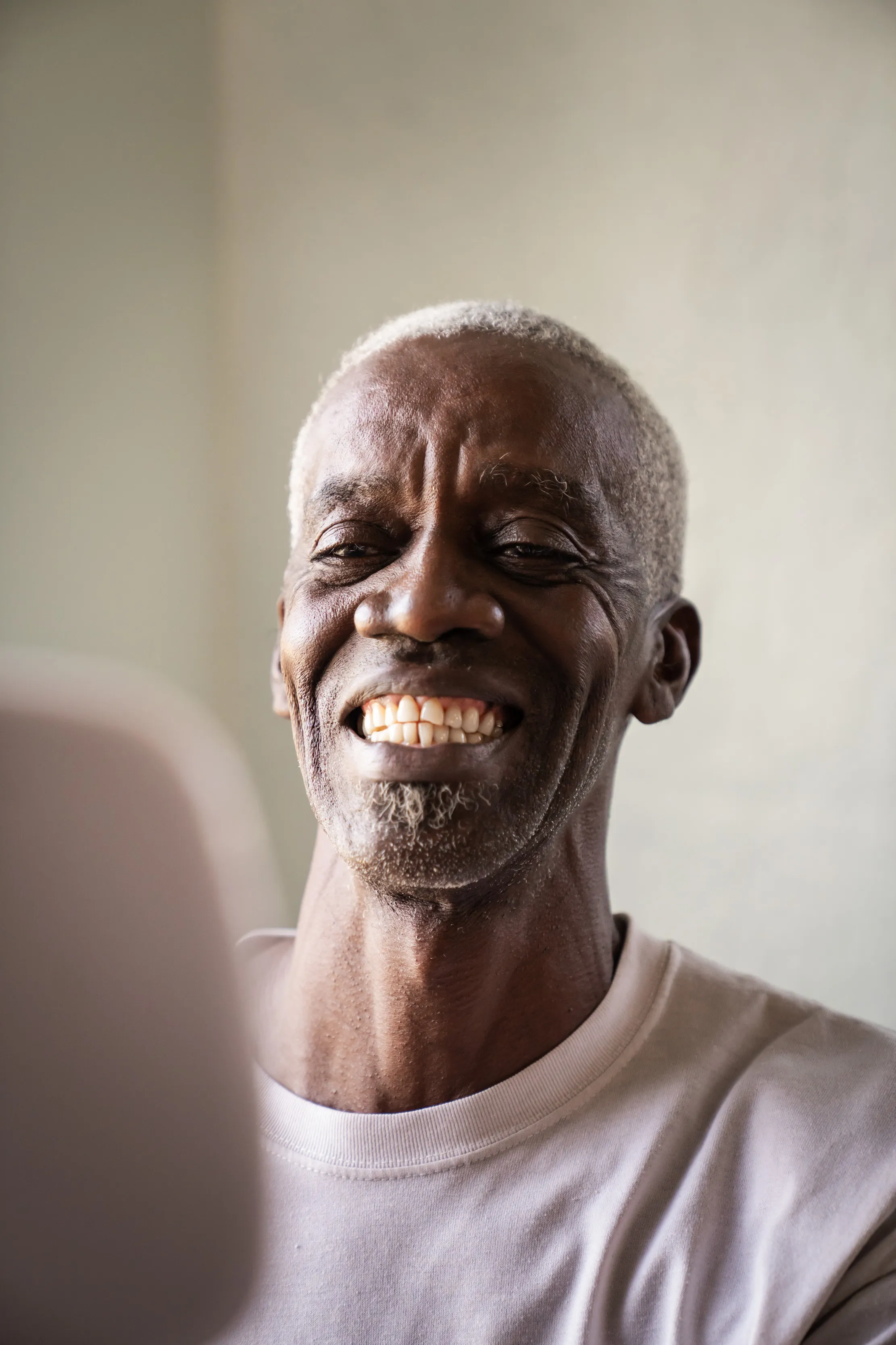 A patient smiling after receiving care at a GLO Good Foundation mission