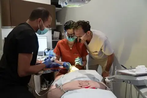 Smile House doctors examining a patient's gums