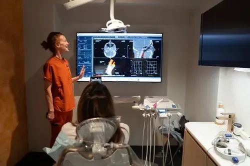A Smile House clinician walking a patient through 3D airway images