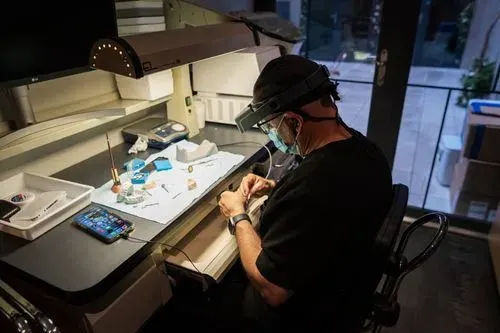 A lab technician crafting a custom dental appliance