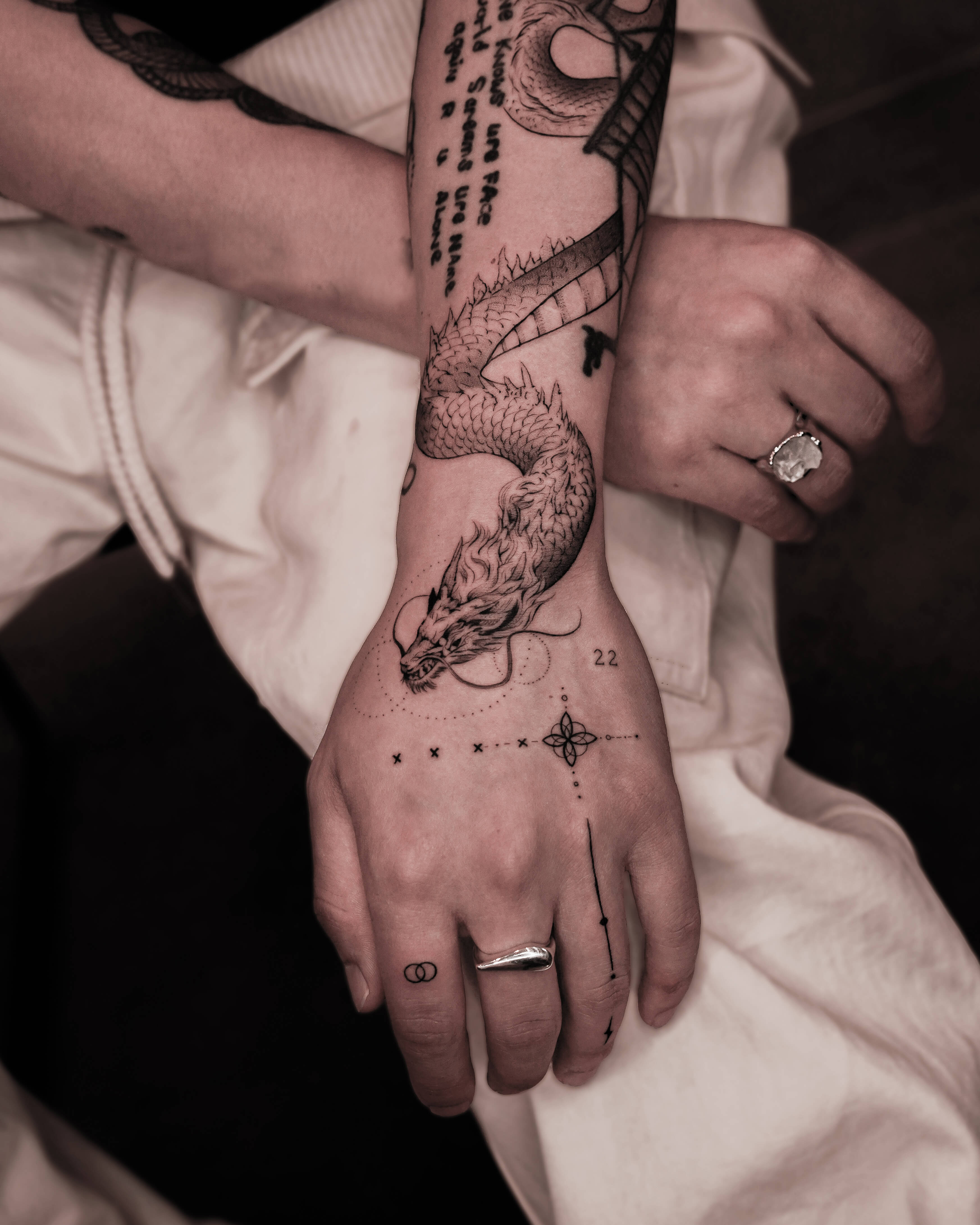 Dragon tattoos have been a cornerstone of tattoo culture across civilizations for centuries — and they remain one of the most powerful, versatile, and deeply symbolic subjects in contemporary body art. Whether you're drawn to the majesty of a Japanese dragon, the bold lines of American traditional, or a fine line dragon rendered with modern precision, this guide covers every aspect of dragon tattoo meaning, designs, styles, and placement.