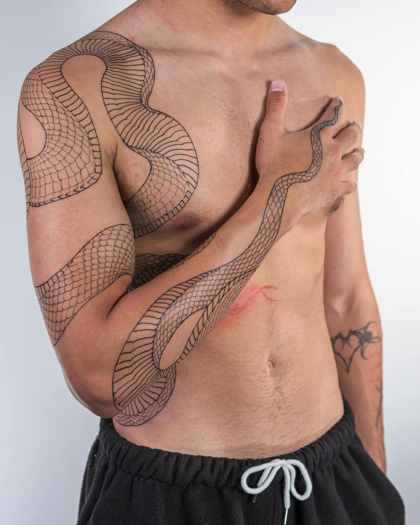 The snake has been tattooed on human skin for thousands of years — longer than almost any other subject in body art. It shows up in ancient Egypt, in Greek mythology, in Japanese folklore, in indigenous traditions across every continent. That kind of staying power doesn't happen by accident. Something about the snake speaks to something deep. This guide breaks down what snake tattoos actually mean, the different cultural traditions behind them, and the design directions worth considering.