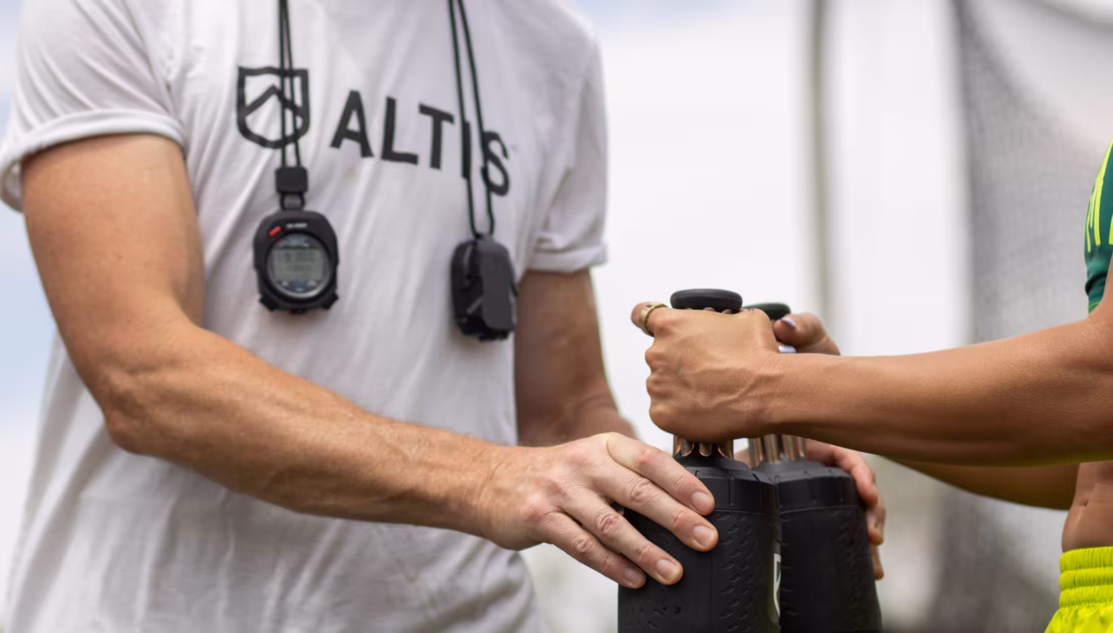 Coach hands palm cooling device to athlete
