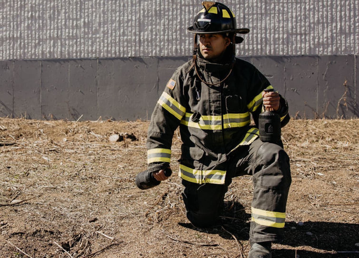 Firefighter holds palm cooling device for heat stress mitigation during incident rehab