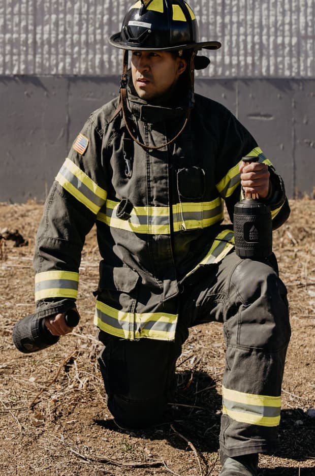 Firefighter holding personal cooling device