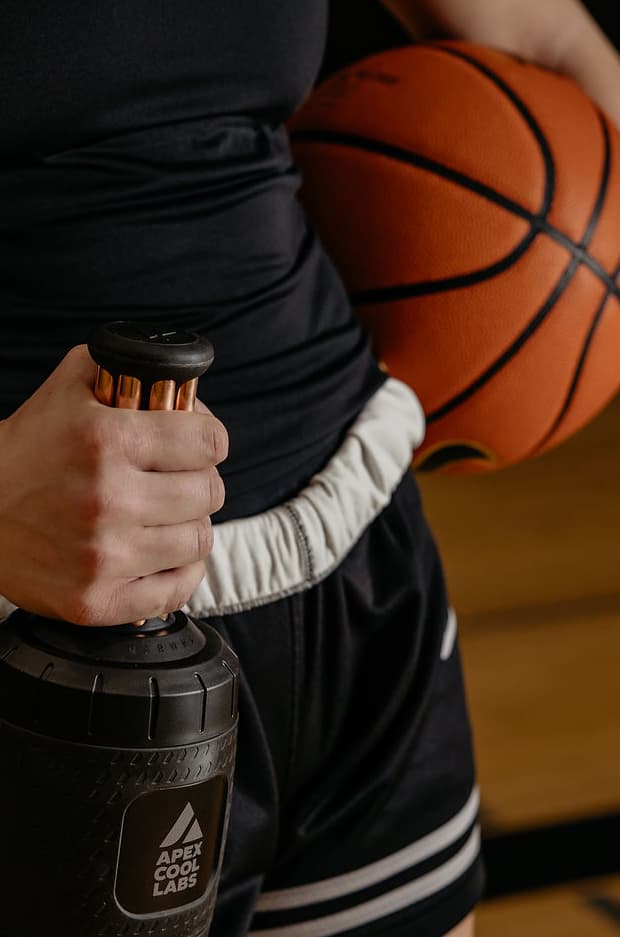 Athlete holding palm cooling device for recovery