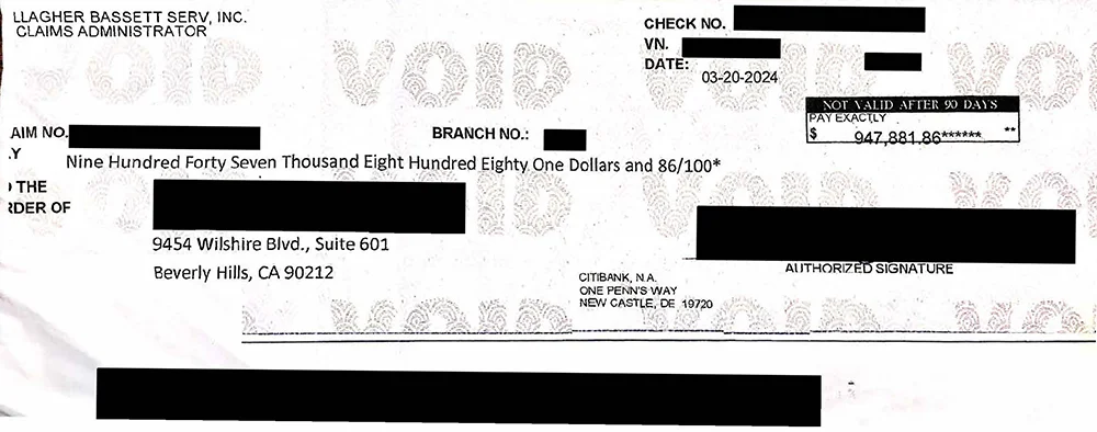 A settlement check for $947,880
