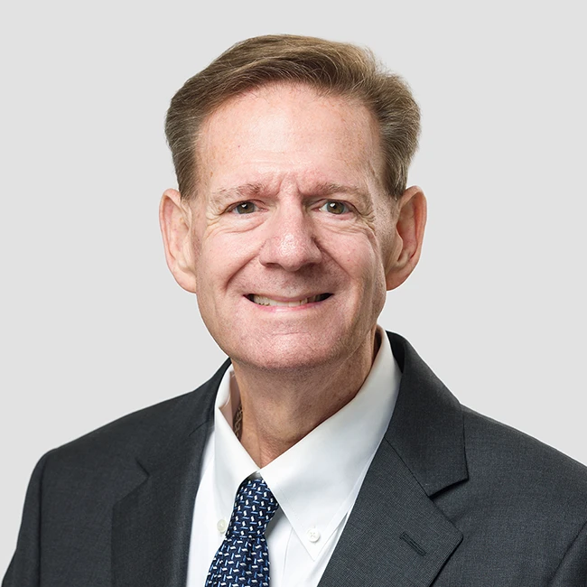 Bernard J. Thalheimer, Senior Trial Attorney at California Attorney Group, wearing a dark suit and tie, smiling against a neutral background.