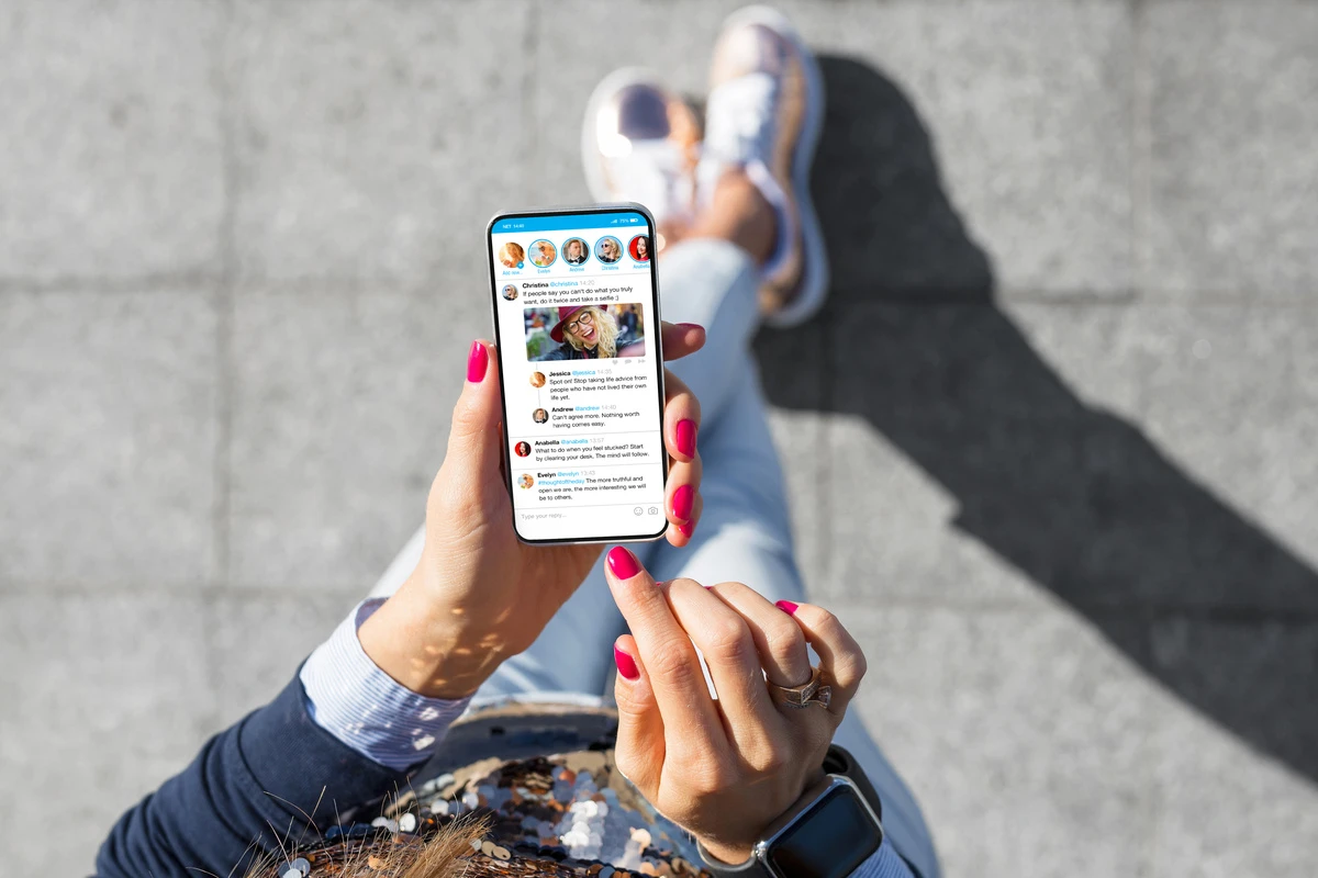 A person using social media on their phone, illustrating how online posts can impact a personal injury claim after an accident in California.