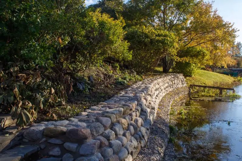 stone retaining wall as part of lakefront backyard landscaping