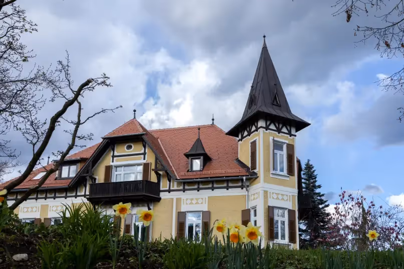 yellow victorian style home with a large turret